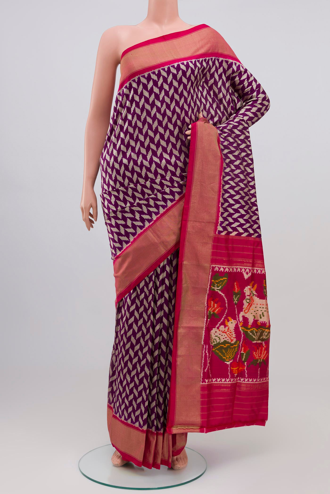 Purple Pochampally Silk Saree with Ikat design on the body and Zari Border.  displayed on a mannequin