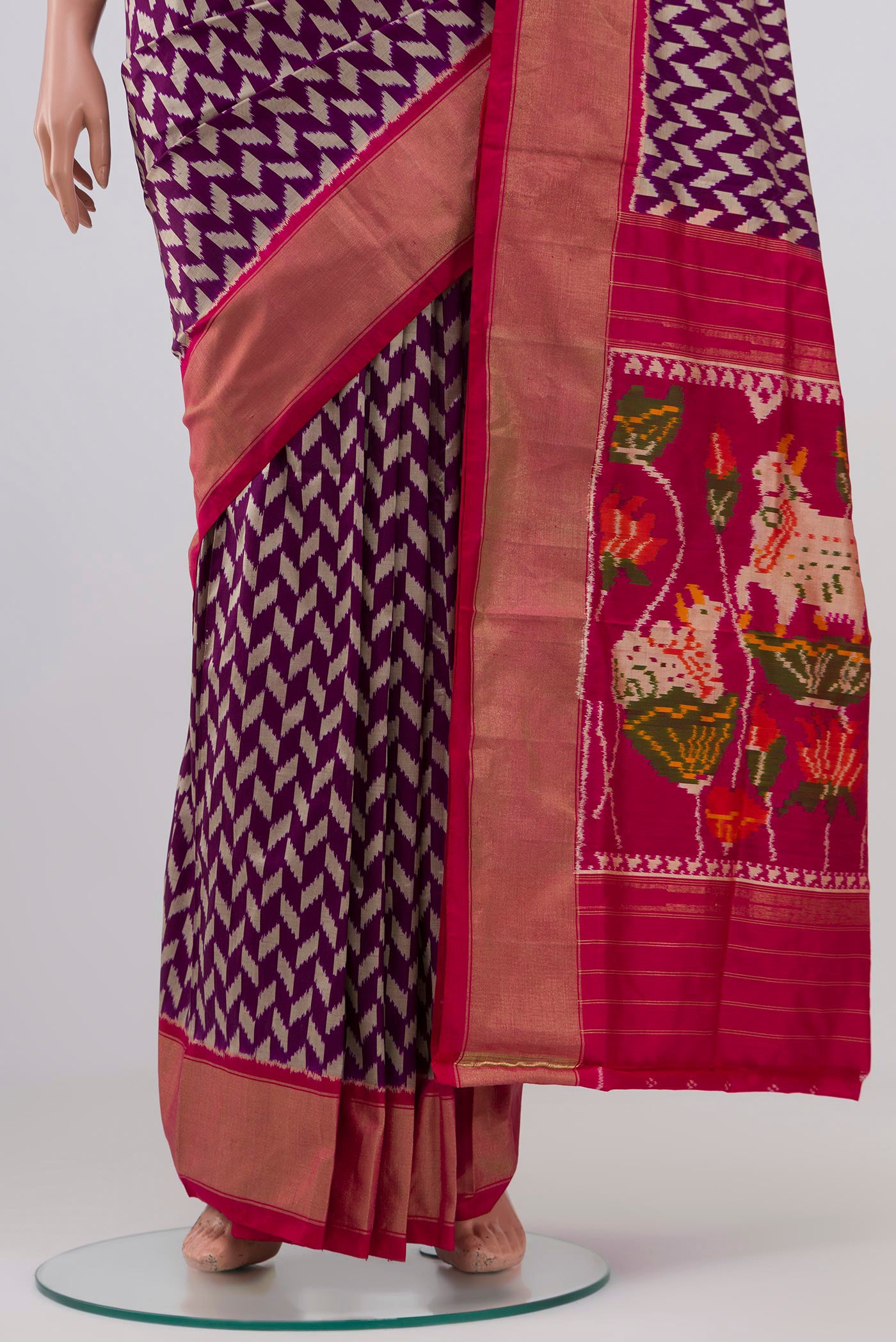Pleats and pallu of Purple Pochampally Silk Saree with Ikat design on the body and Zari Border. 