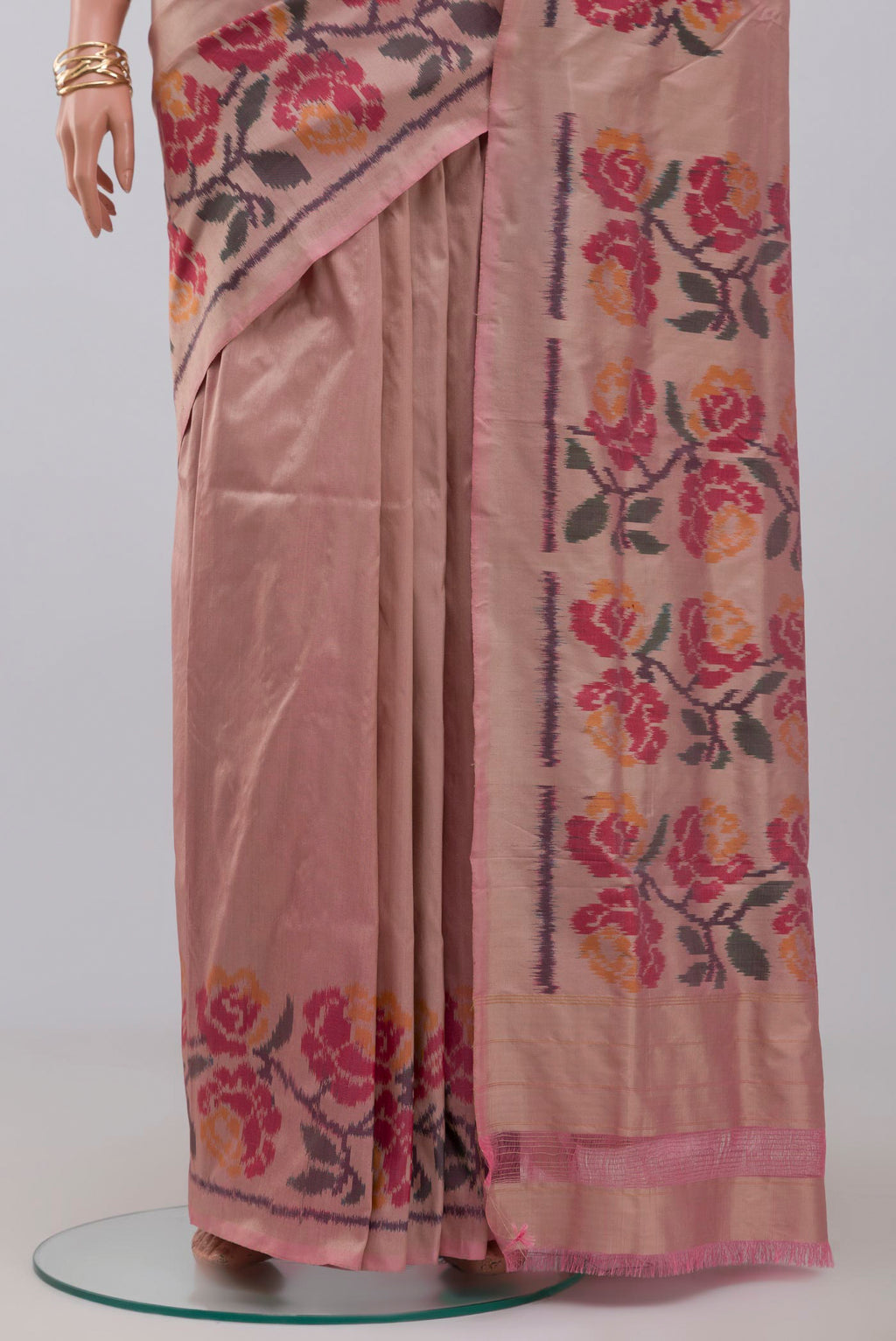 Pleats and pallu of Peach Pochampally Silk Saree with Ikat design on the body and Ikat Border. 