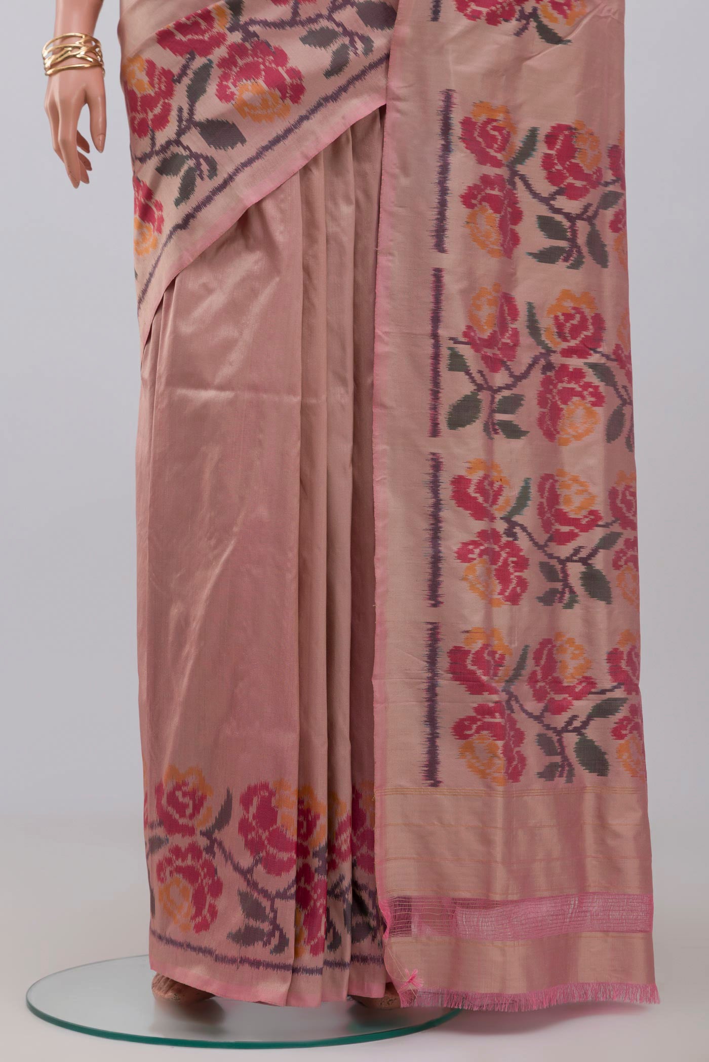 Pleats and pallu of Peach Pochampally Silk Saree with Ikat design on the body and Ikat Border. 