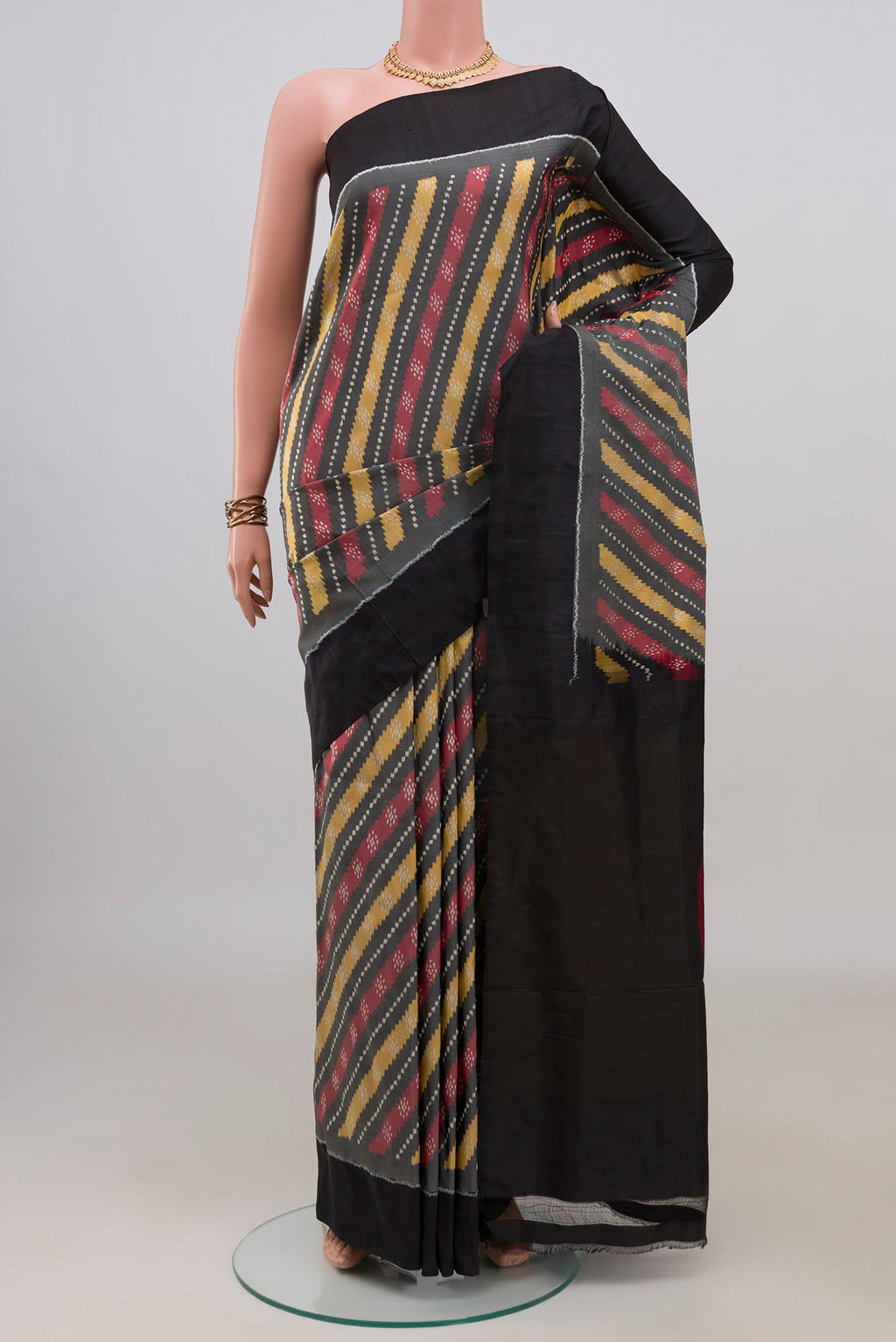 Pure Silk Grey Pochampally Saree with Ikat design on the body and Plain Border.  displayed on a mannequin