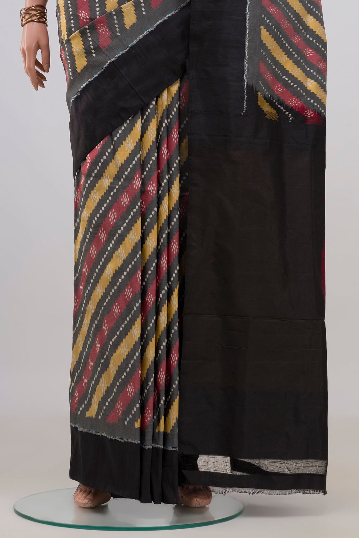 Pleats and pallu of Pure Silk Grey Pochampally Saree with Ikat design on the body and Plain Border. 