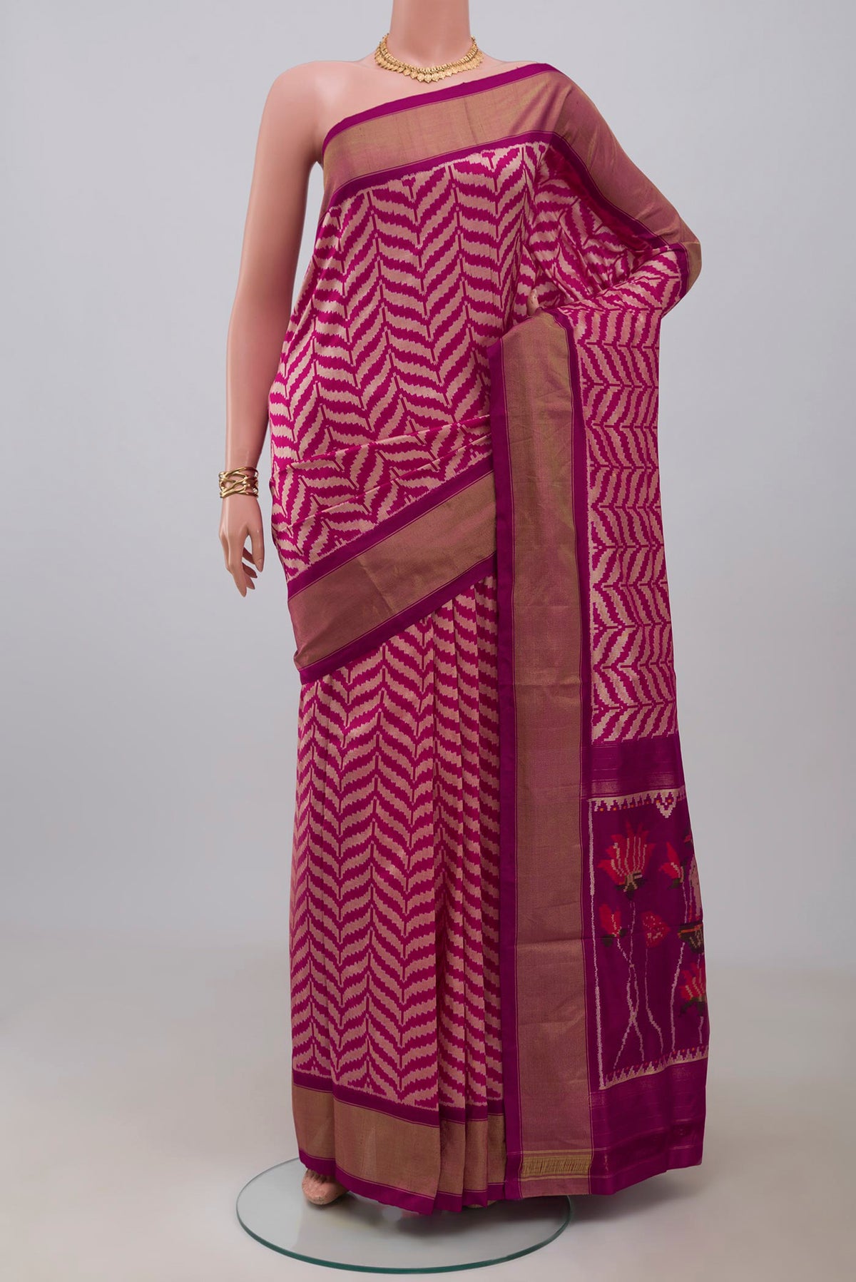 Pink Pochampally Saree with Ikat design on the body and Zari Border.  displayed on a mannequin