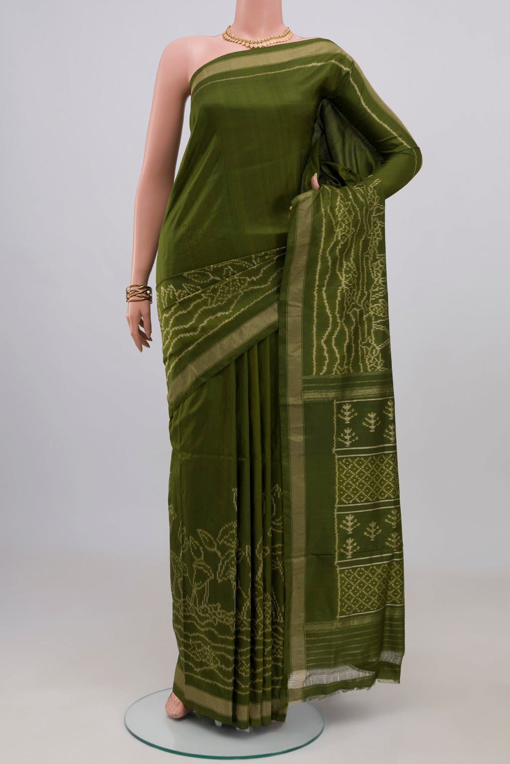 Mehandi Green Pochampally Silk Saree with Ikat design on the body and Thin Zari Line.  displayed on a mannequin