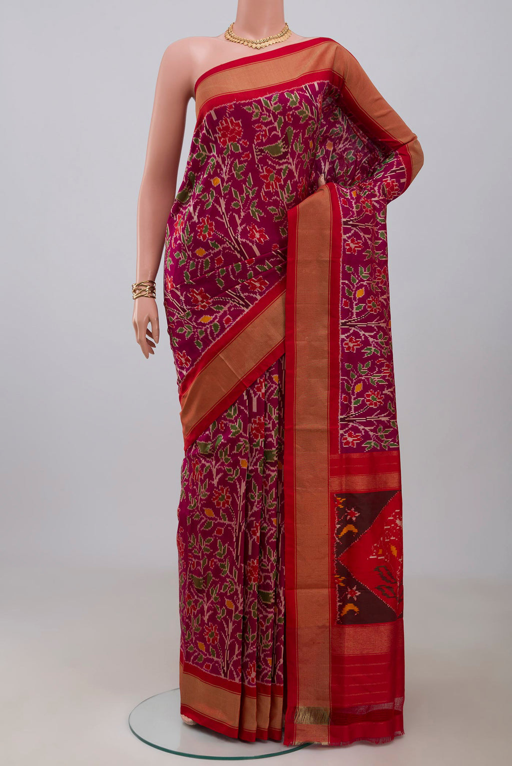 Magenta Pochampally Saree with Ikat design on the body and Zari Border.  displayed on a mannequin