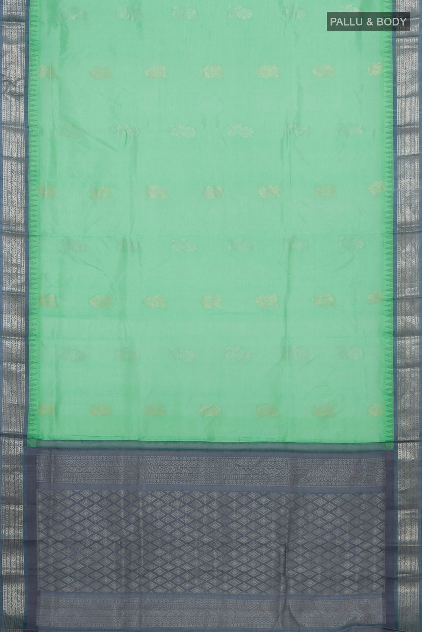Flat view of Green Silk Cotton Saree with Zari Butta on the body and Zari Border. 