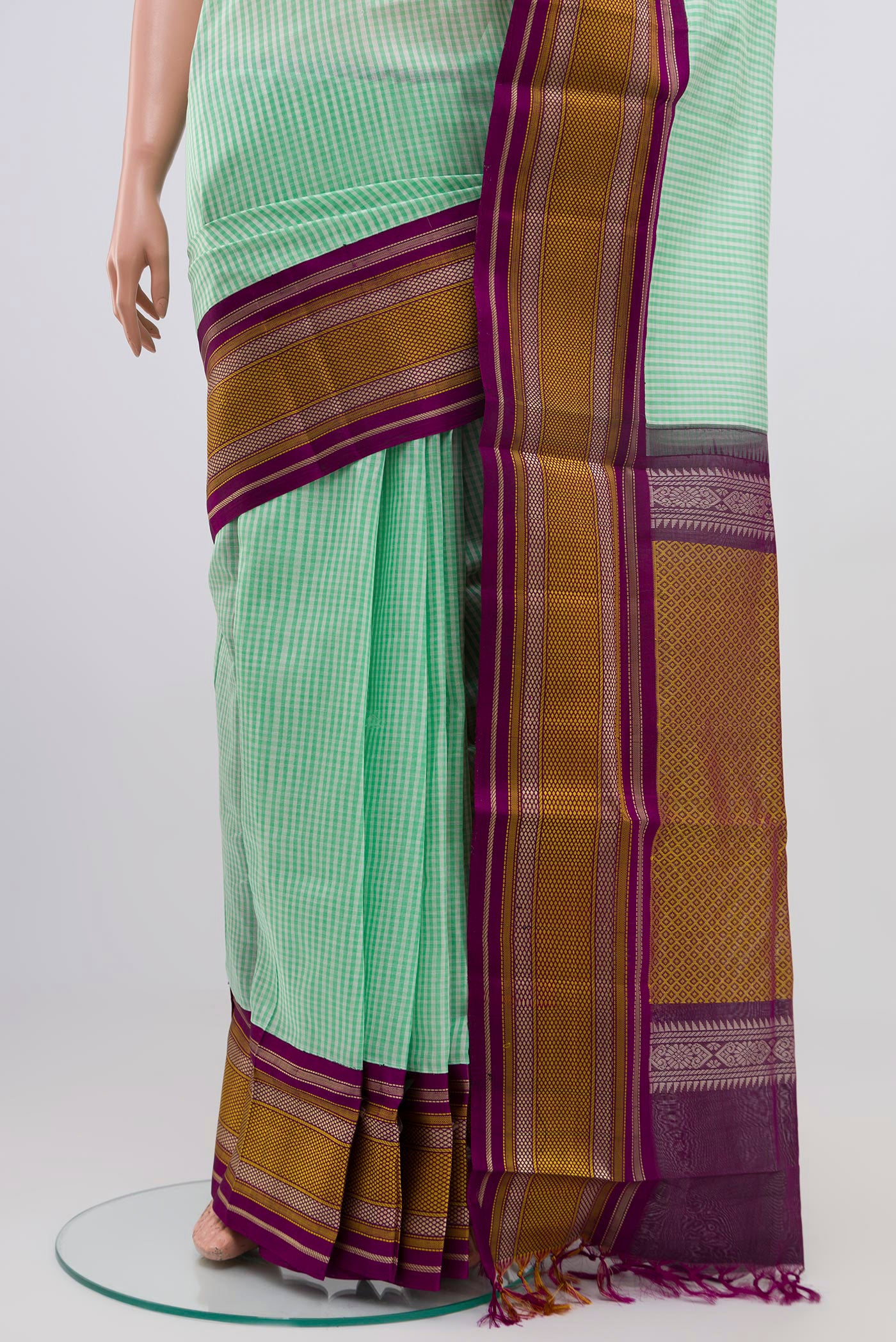 Pleats and pallu of Green Silk Cotton Saree with Checked design on the body and Thread Border. 