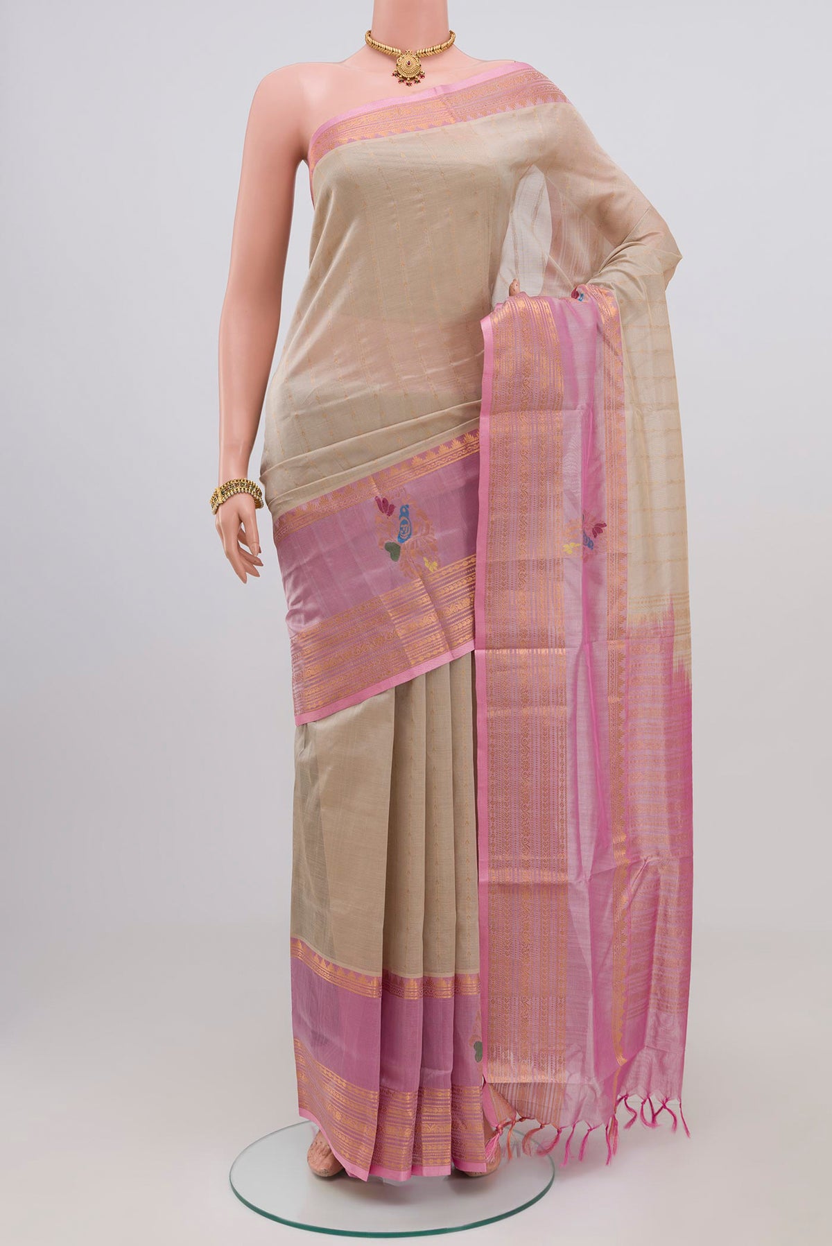 Cream Silk Cotton Saree with Stripes on the body and Zari Border.  displayed on a mannequin
