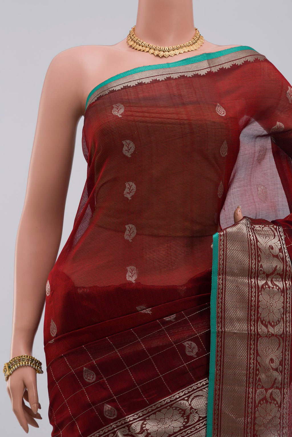 Border image of Maroon Silk Cotton Saree with Zari Butta on the body and Zari Border. 