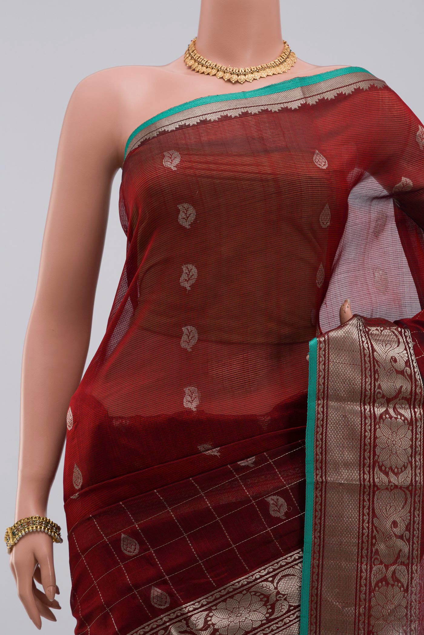Border image of Maroon Silk Cotton Saree with Zari Butta on the body and Zari Border. 