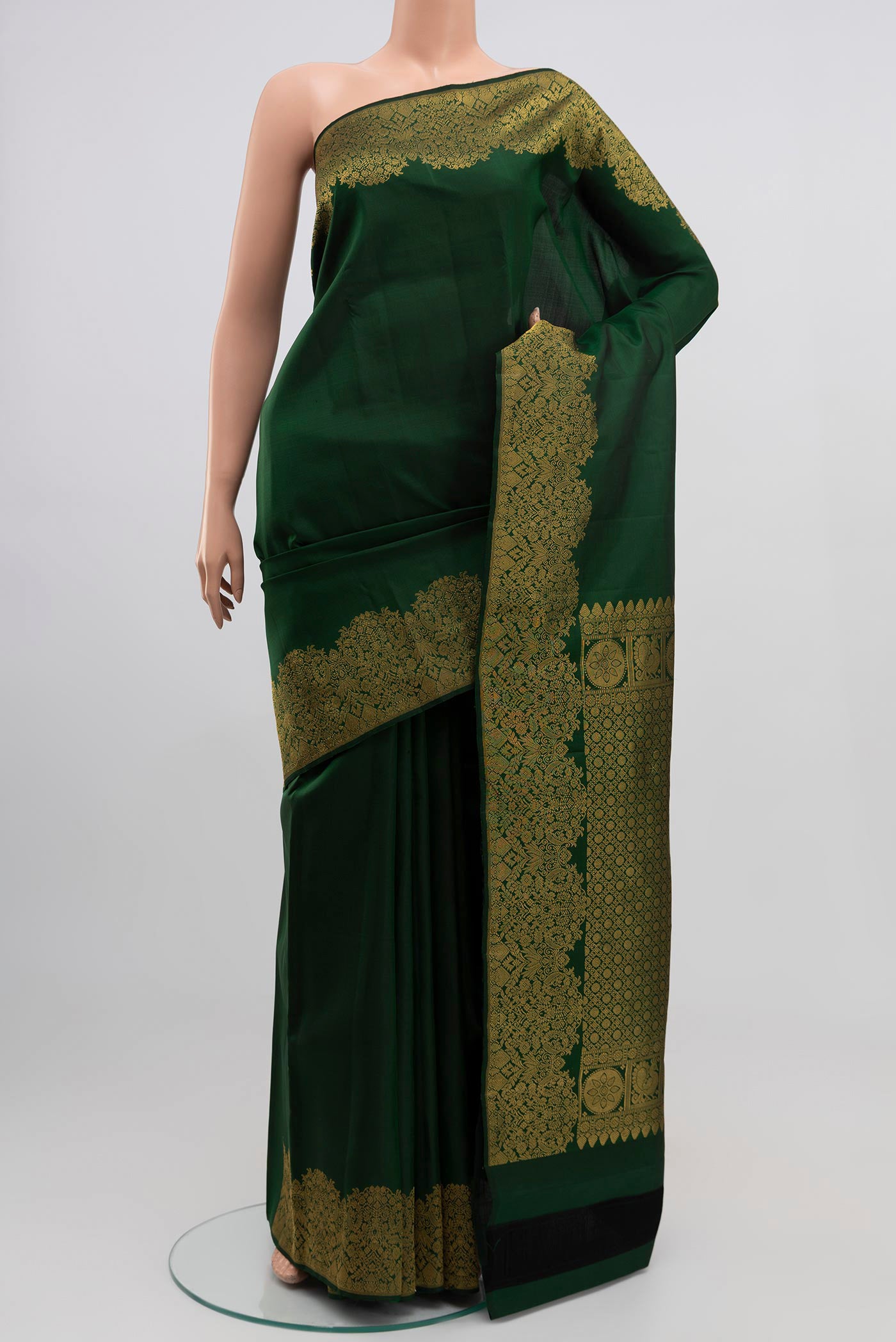 Green Kanchipuram Silk Saree with Plain Body and Zari Border.  displayed on a mannequin