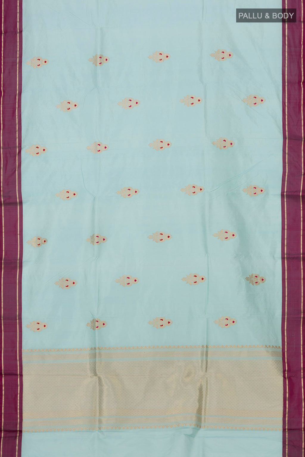 Flat view of Light Blue Banarasi Katan Silk Saree with Zari Butta on the body and Plain Border. 
