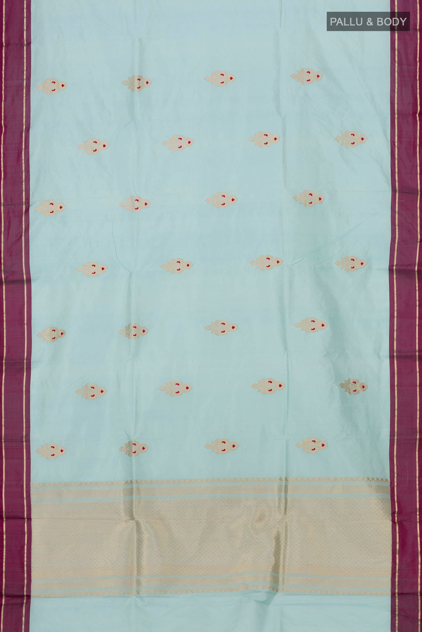 Flat view of Light Blue Banarasi Katan Silk Saree with Zari Butta on the body and Plain Border. 