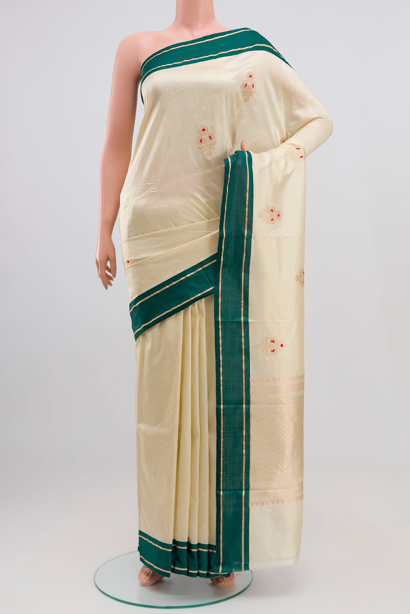 Cream Banarasi Katan Silk Saree with Zari Butta on the body and Thin Zari Line.  displayed on a mannequin