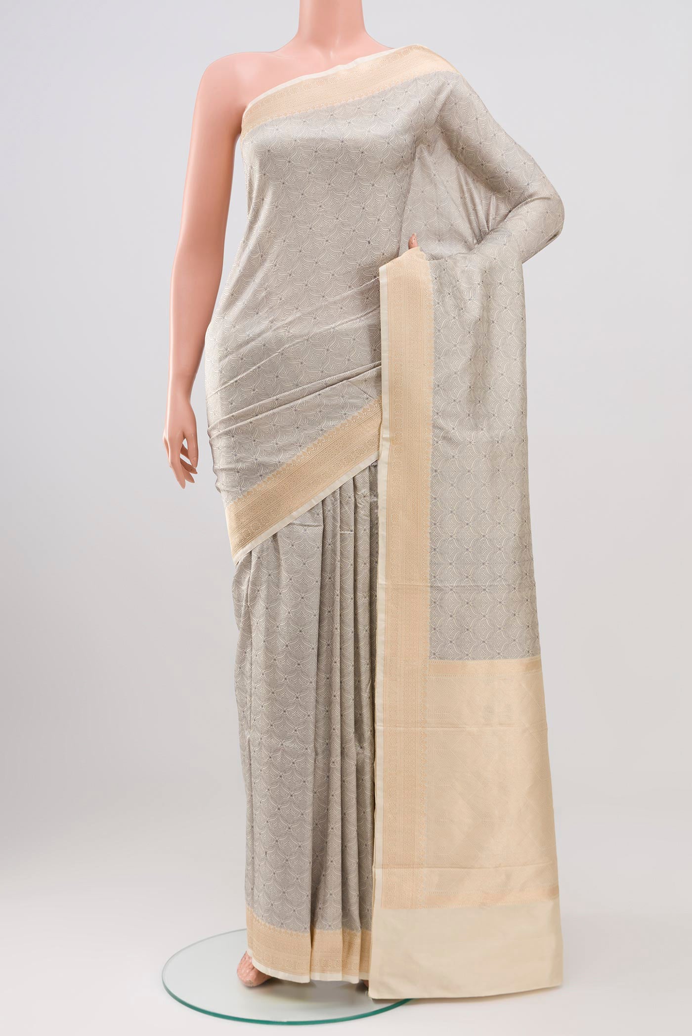 Cream Banarasi Katan Silk Saree with Jacquard design on the body and Thread Border.  displayed on a mannequin