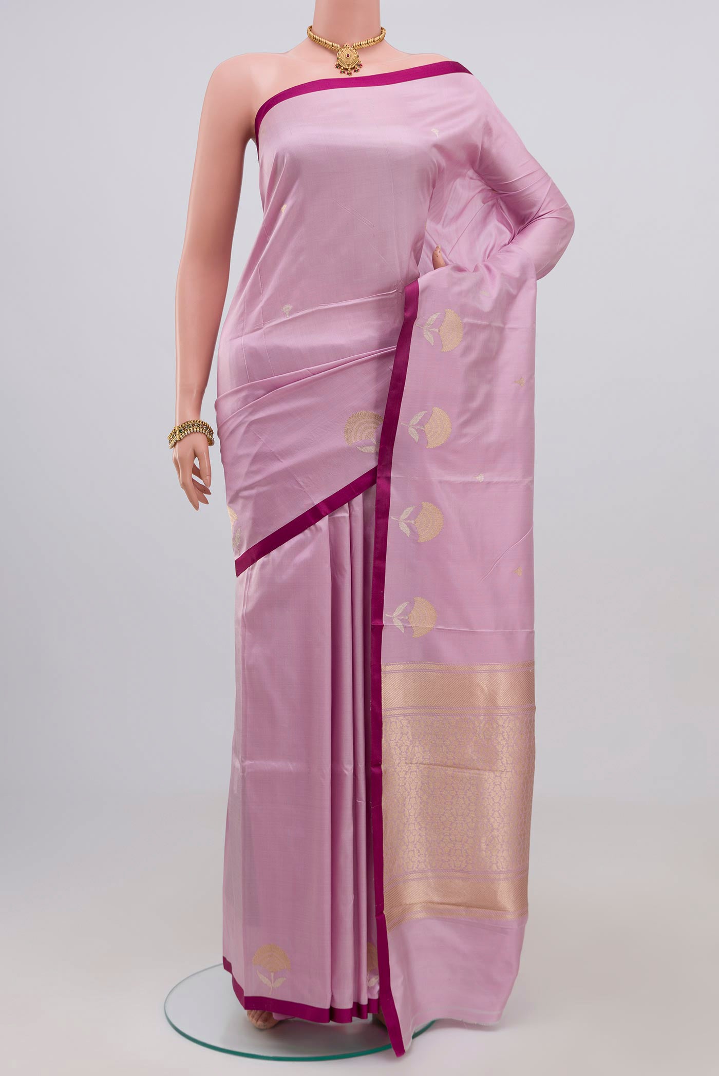 Lavender Banarasi Katan Silk Saree with Zari Butta on the body and Plain Border.  displayed on a mannequin
