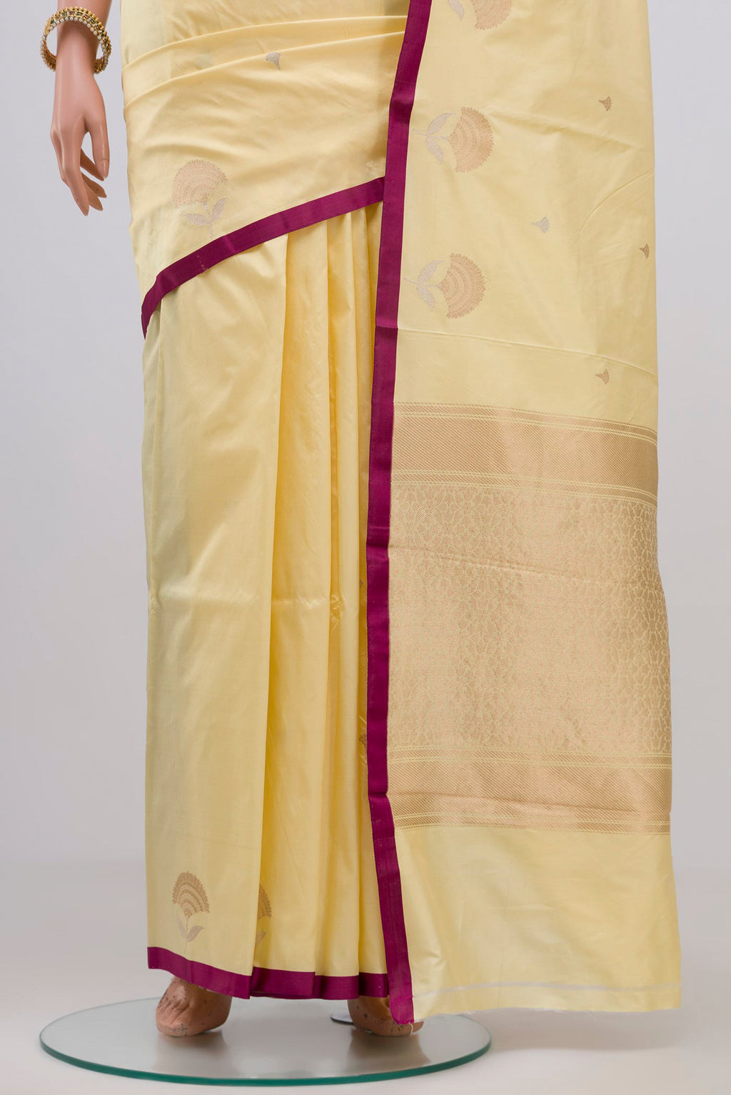 Pleats and pallu of Yellow Banarasi Katan Silk Saree with Zari Butta on the body and Plain Border. 