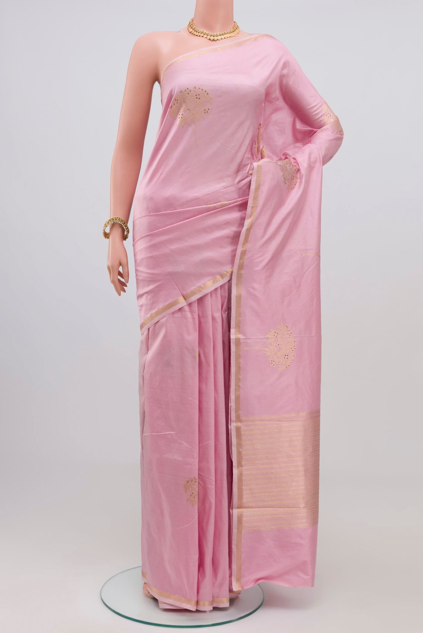 Rose pink Banarasi Katan Silk Saree with Zari Butta on the body and Zari Border.  displayed on a mannequin