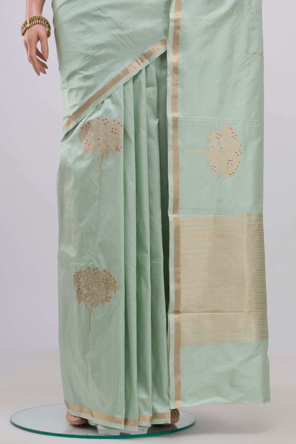 Pleats and pallu of Light Green Banarasi Katan Silk Saree with Zari Butta on the body and Thin Zari Line. 