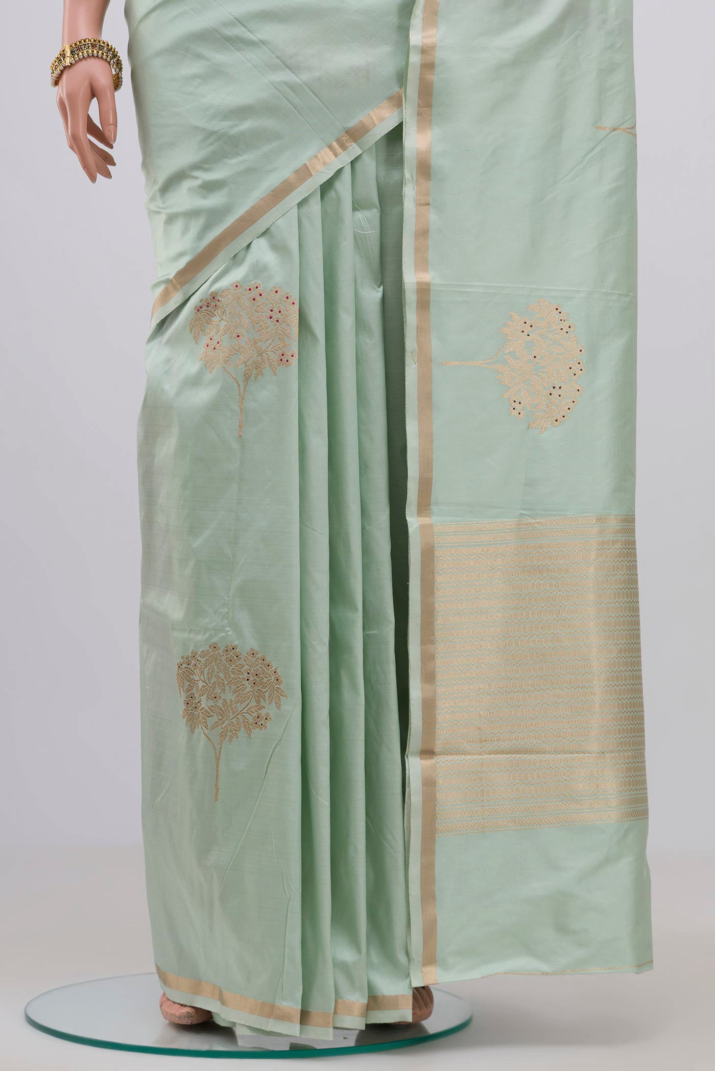 Pleats and pallu of Light Green Banarasi Katan Silk Saree with Zari Butta on the body and Thin Zari Line. 