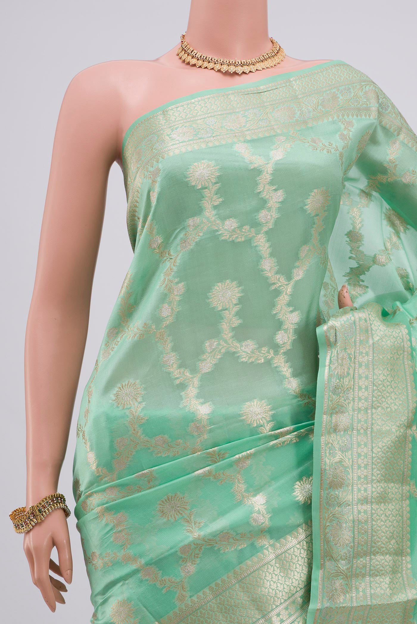 Border image of Light Green Raw Silk Saree with Zari Butta on the body and Zari Border. 
