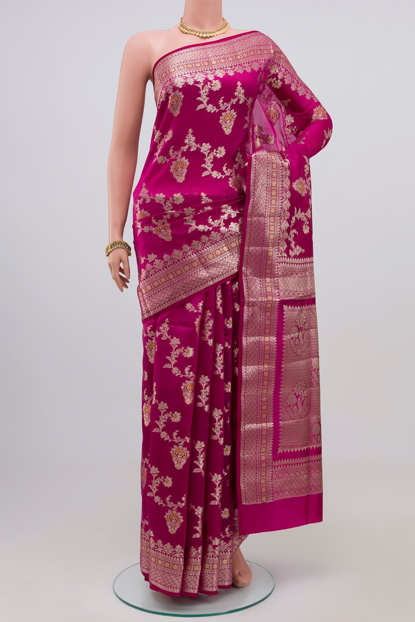Rani Pink Raw Silk Saree with Zari Butta on the body and Zari Border.  displayed on a mannequin