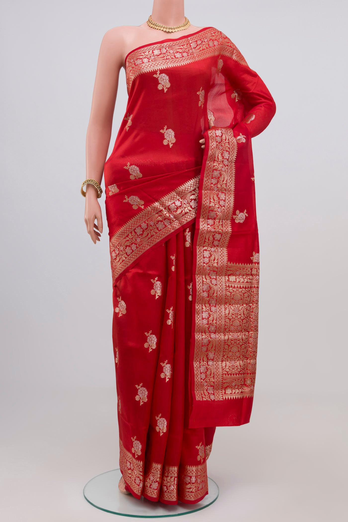 Red Raw Silk Saree with Zari Butta on the body and Zari Border.  displayed on a mannequin