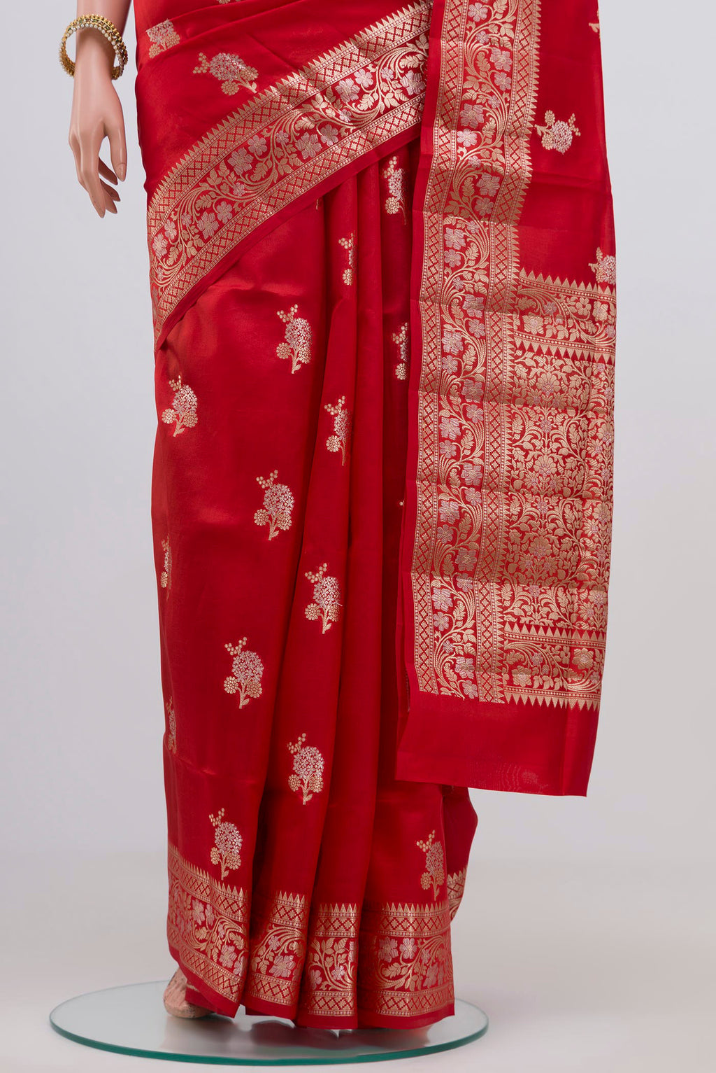 Pleats and pallu of Red Raw Silk Saree with Zari Butta on the body and Zari Border. 