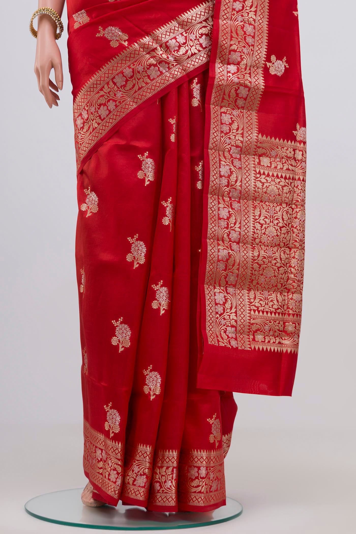 Pleats and pallu of Red Raw Silk Saree with Zari Butta on the body and Zari Border. 