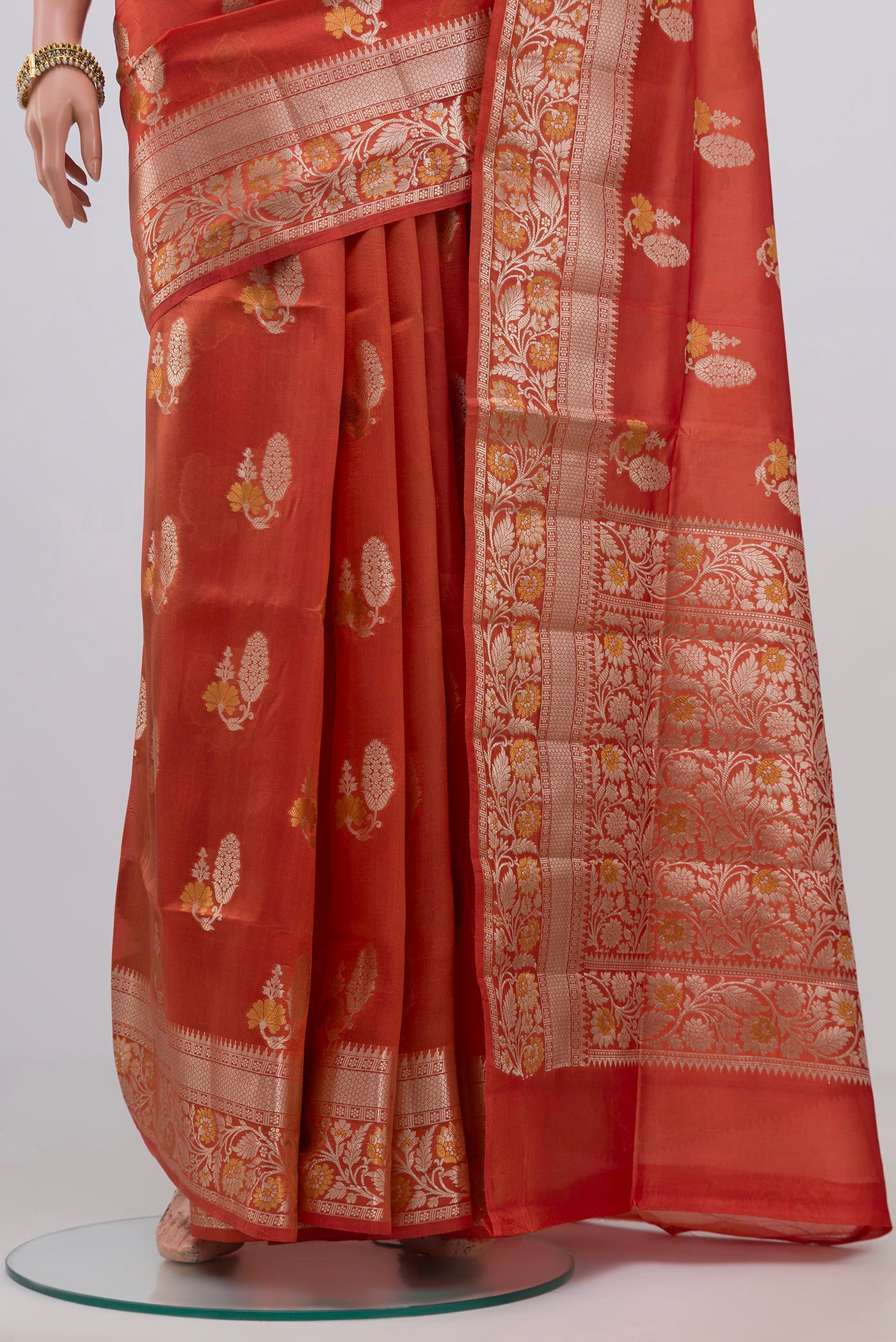 Pleats and pallu of Peach Raw Silk Saree with Zari Butta on the body and Zari Border. 
