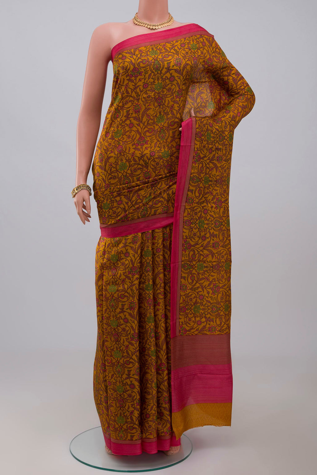 Yellow Printed Silk Saree with Printed design on the body and Plain Border.  displayed on a mannequin