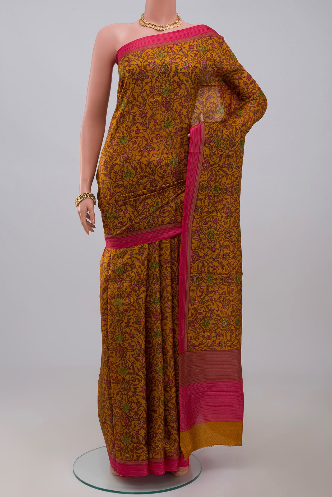 Yellow Printed Silk Saree with Printed design on the body and Plain Border.  displayed on a mannequin