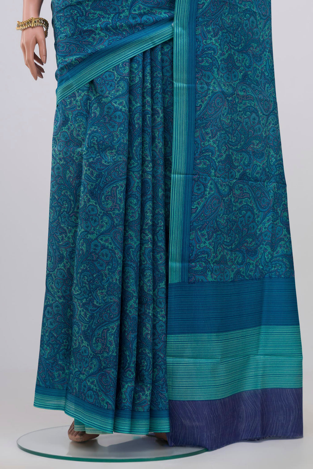 Pleats and pallu of Blue Printed Silk Saree with Printed design on the body and Plain Border. 