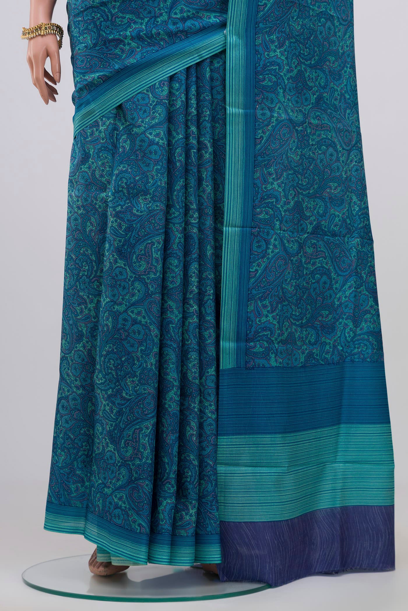 Pleats and pallu of Blue Printed Silk Saree with Printed design on the body and Plain Border. 