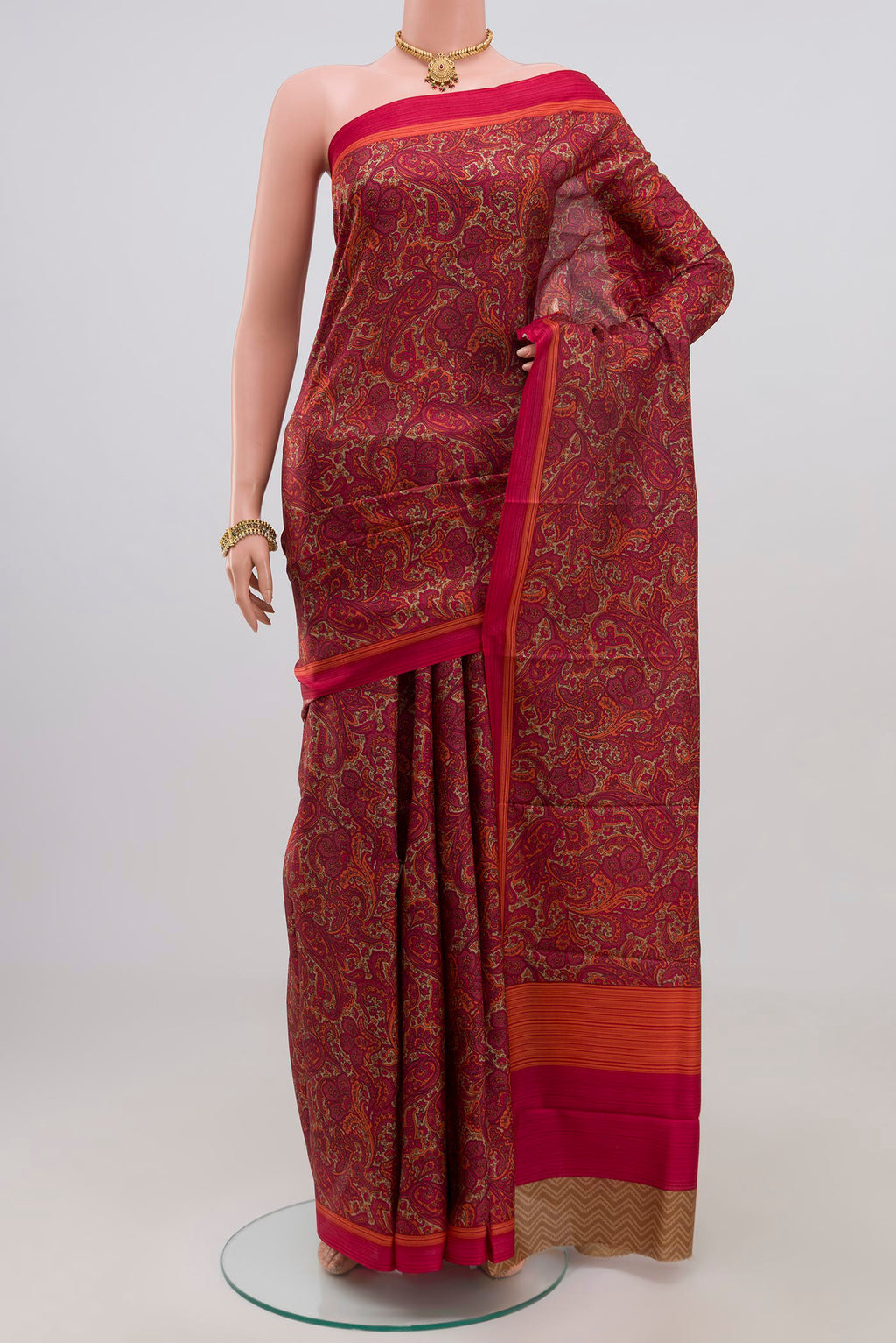 Red Printed Silk Saree with Printed design on the body and Plain Border.  displayed on a mannequin