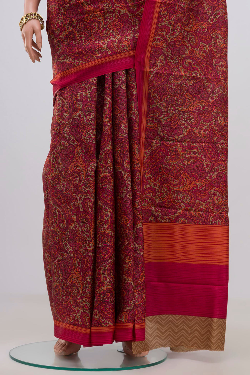 Pleats and pallu of Red Printed Silk Saree with Printed design on the body and Plain Border. 