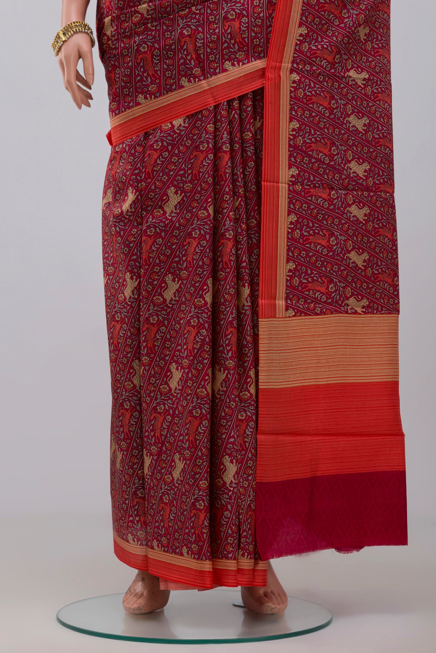 Pleats and pallu of Red Printed Silk Saree with Printed design on the body and Plain Border. 