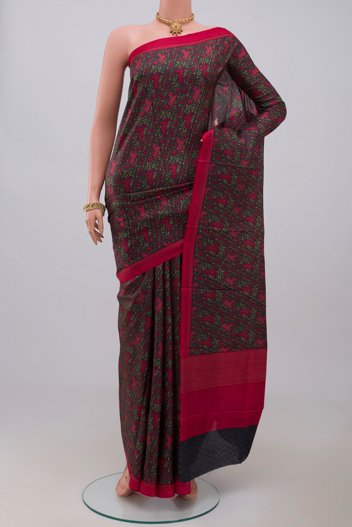 Black Printed Silk Saree with Printed design on the body and Plain Border.  displayed on a mannequin