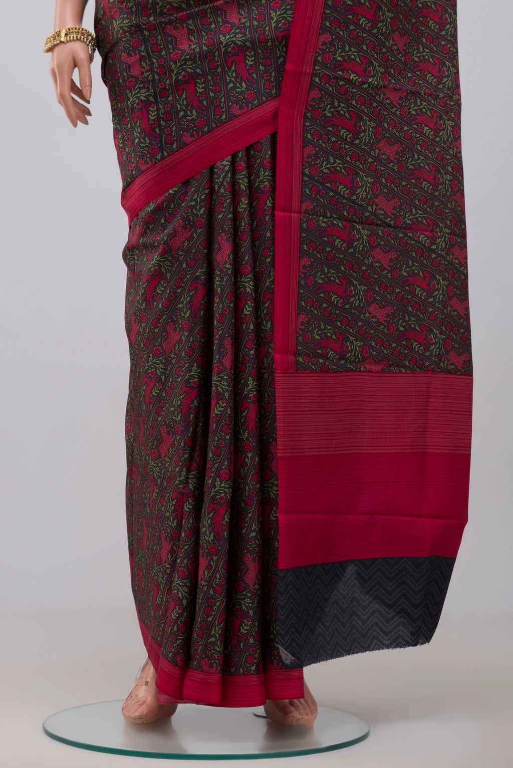 Pleats and pallu of Black Printed Silk Saree with Printed design on the body and Plain Border. 