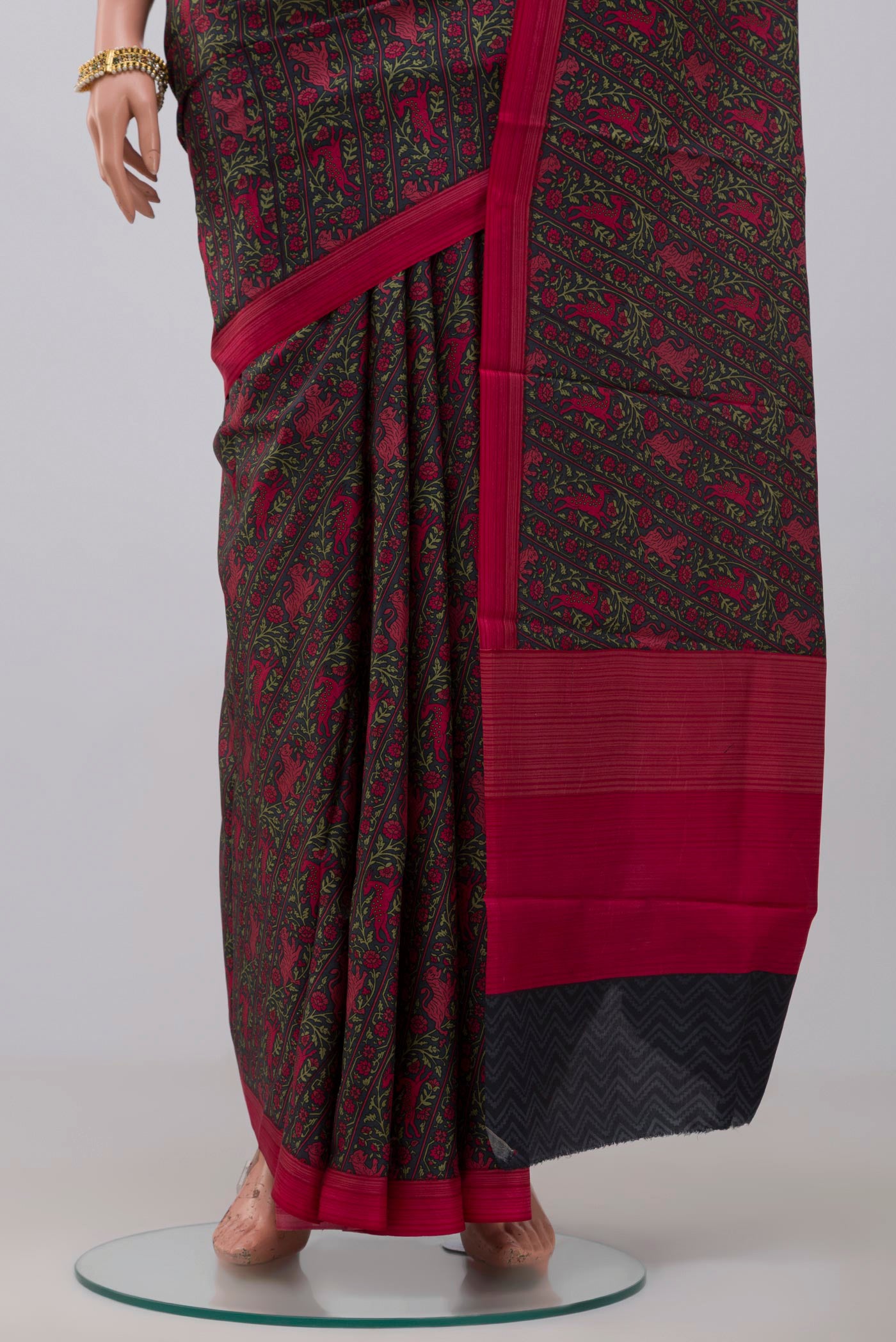 Pleats and pallu of Black Printed Silk Saree with Printed design on the body and Plain Border. 