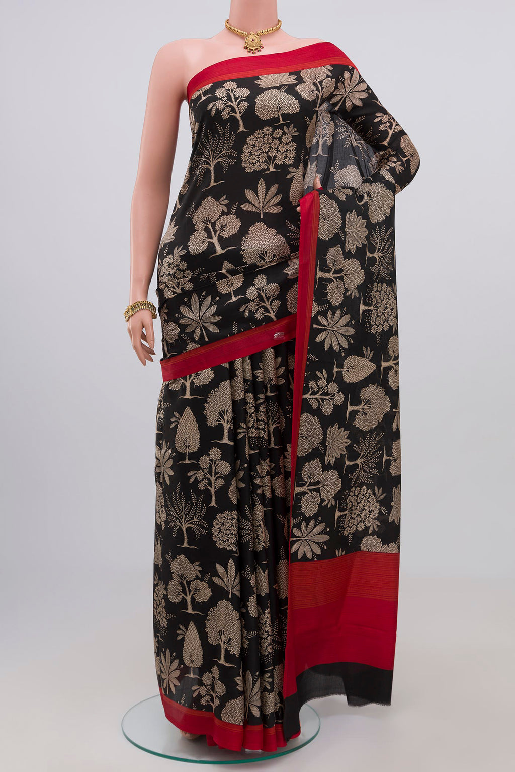 Black Printed Silk Saree with Printed design on the body and Plain Border.  displayed on a mannequin