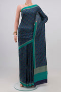 Blue Printed Silk Saree with Printed design on the body and Plain Border.  displayed on a mannequin