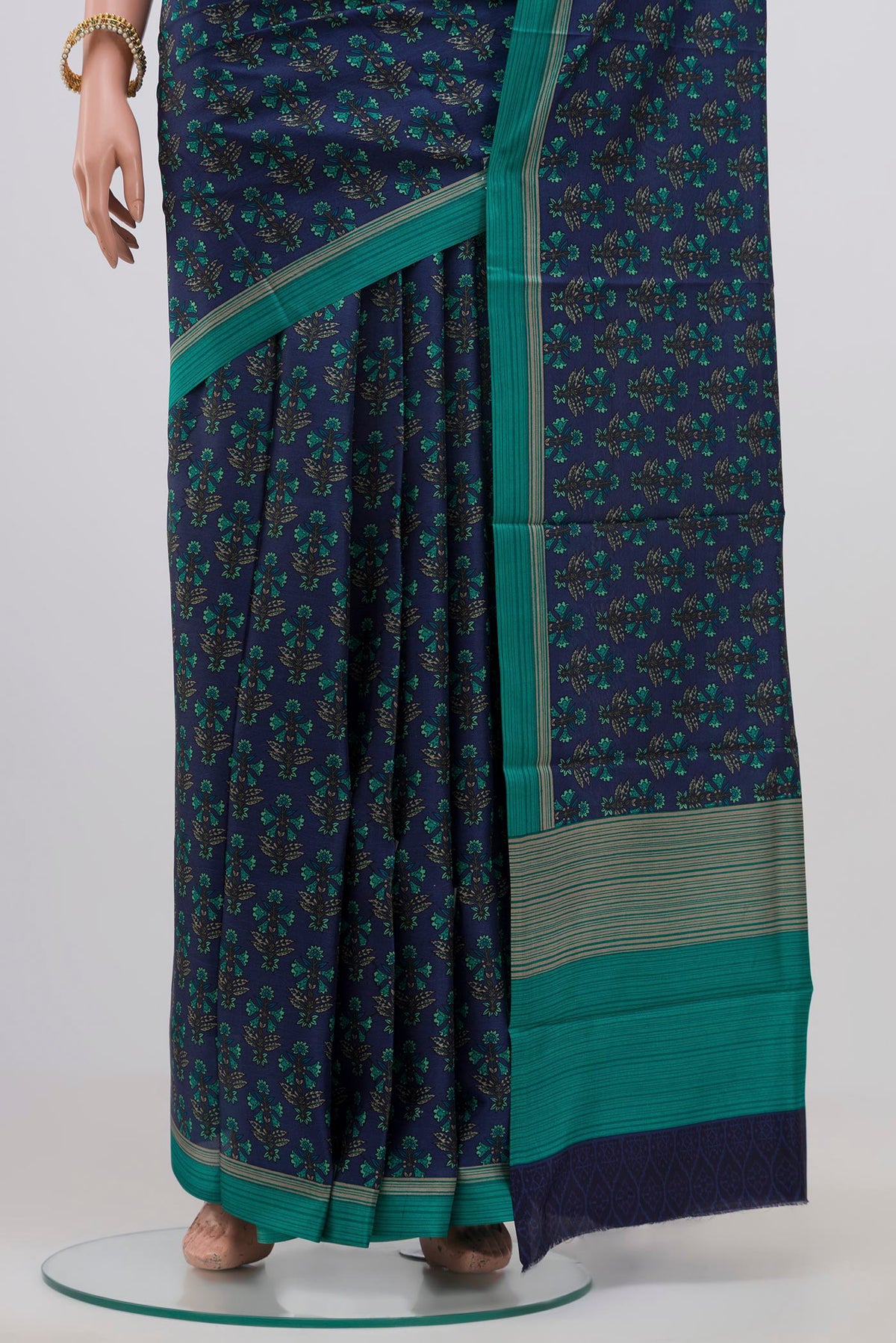 Pleats and pallu of Blue Printed Silk Saree with Printed design on the body and Plain Border. 