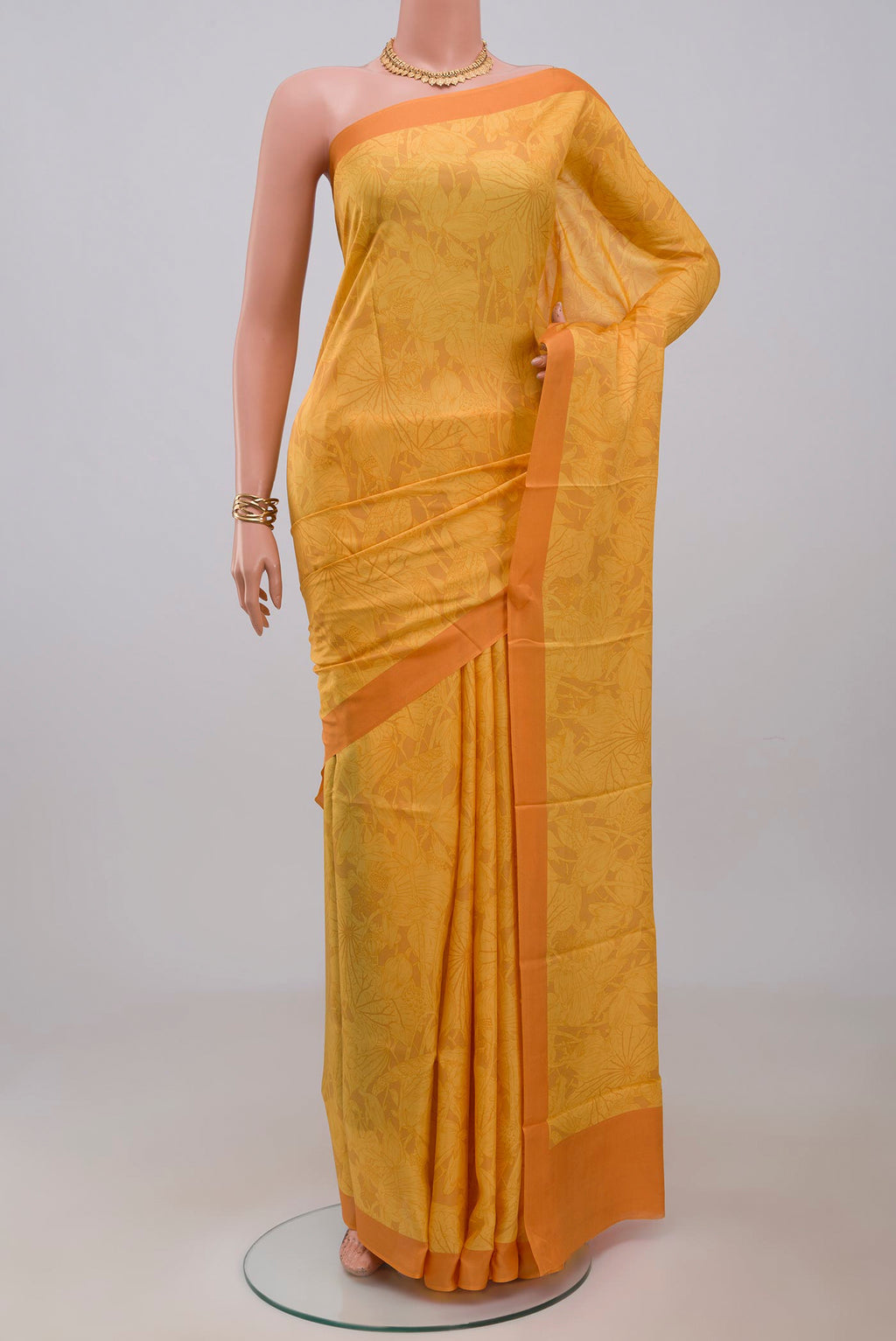 Yellow Printed Silk Saree with Printed design on the body and Plain Border.  displayed on a mannequin