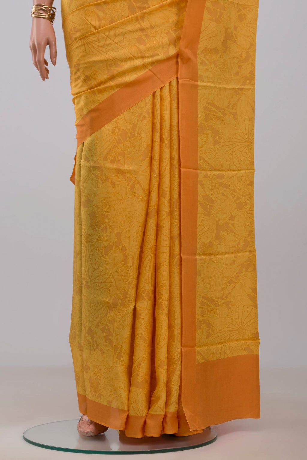 Pleats and pallu of Yellow Printed Silk Saree with Printed design on the body and Plain Border. 