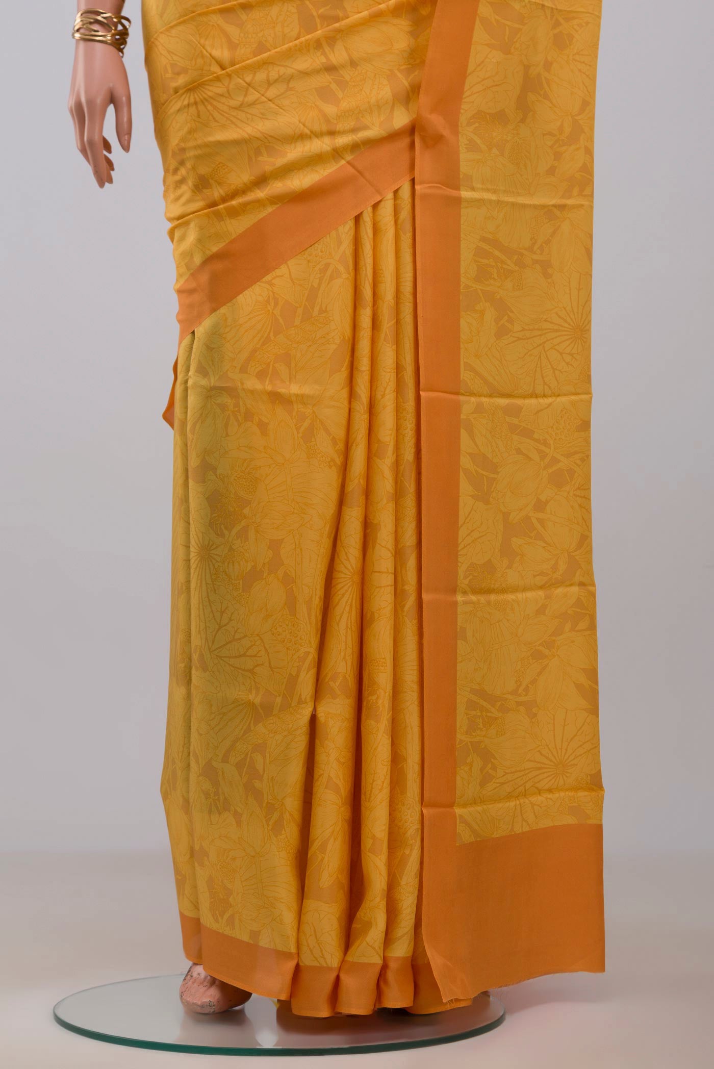 Pleats and pallu of Yellow Printed Silk Saree with Printed design on the body and Plain Border. 