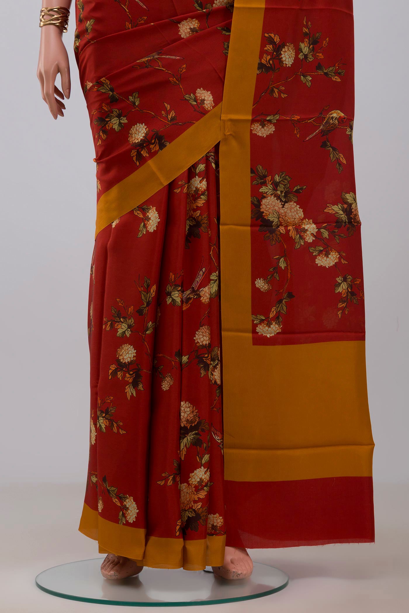 Pleats and pallu of Red Printed Silk Saree with Printed design on the body and Plain Border. 
