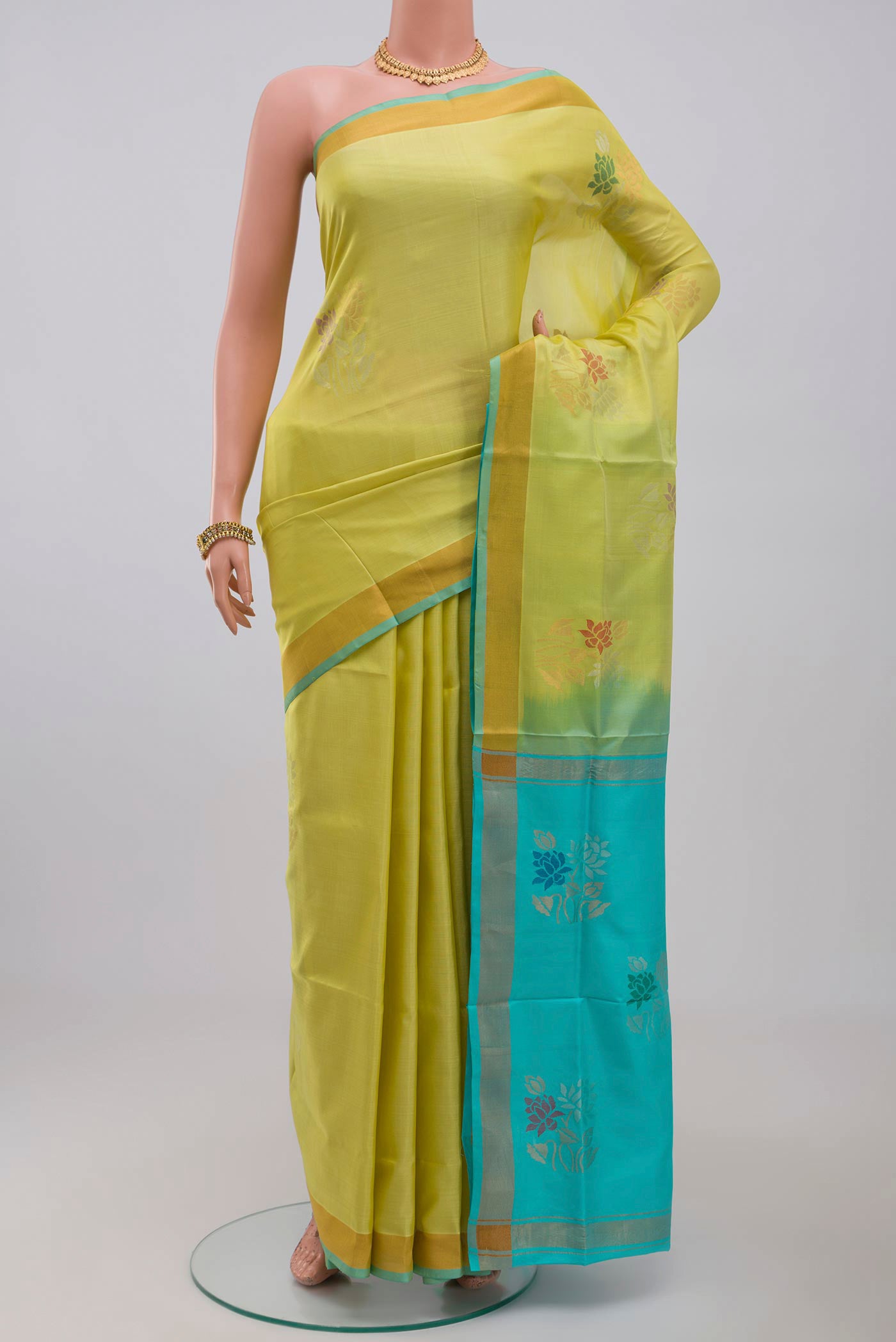 Yellow Uppada Silk Saree with Zari Butta on the body and Zari Border.  displayed on a mannequin
