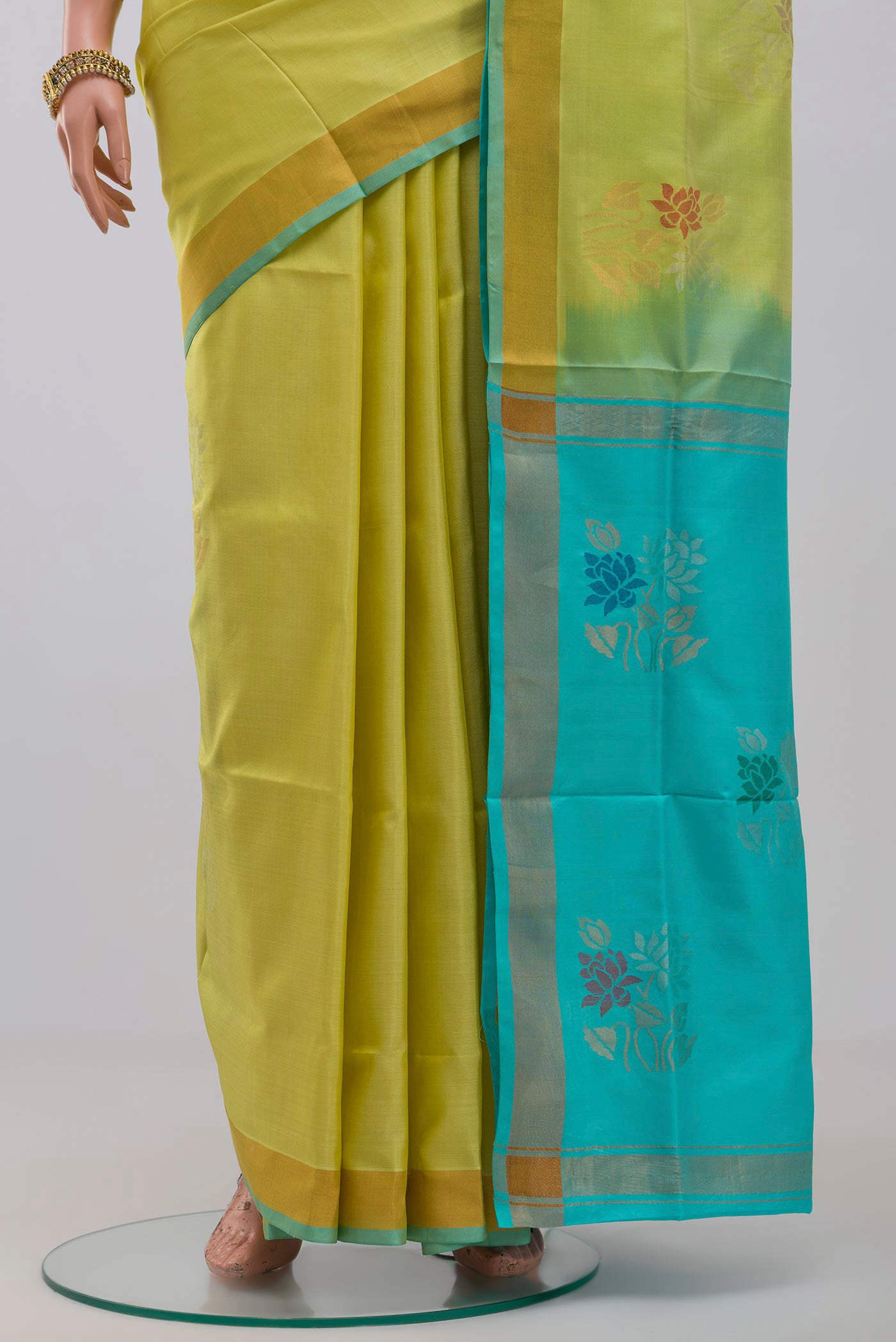 Pleats and pallu of Yellow Uppada Silk Saree with Zari Butta on the body and Zari Border. 