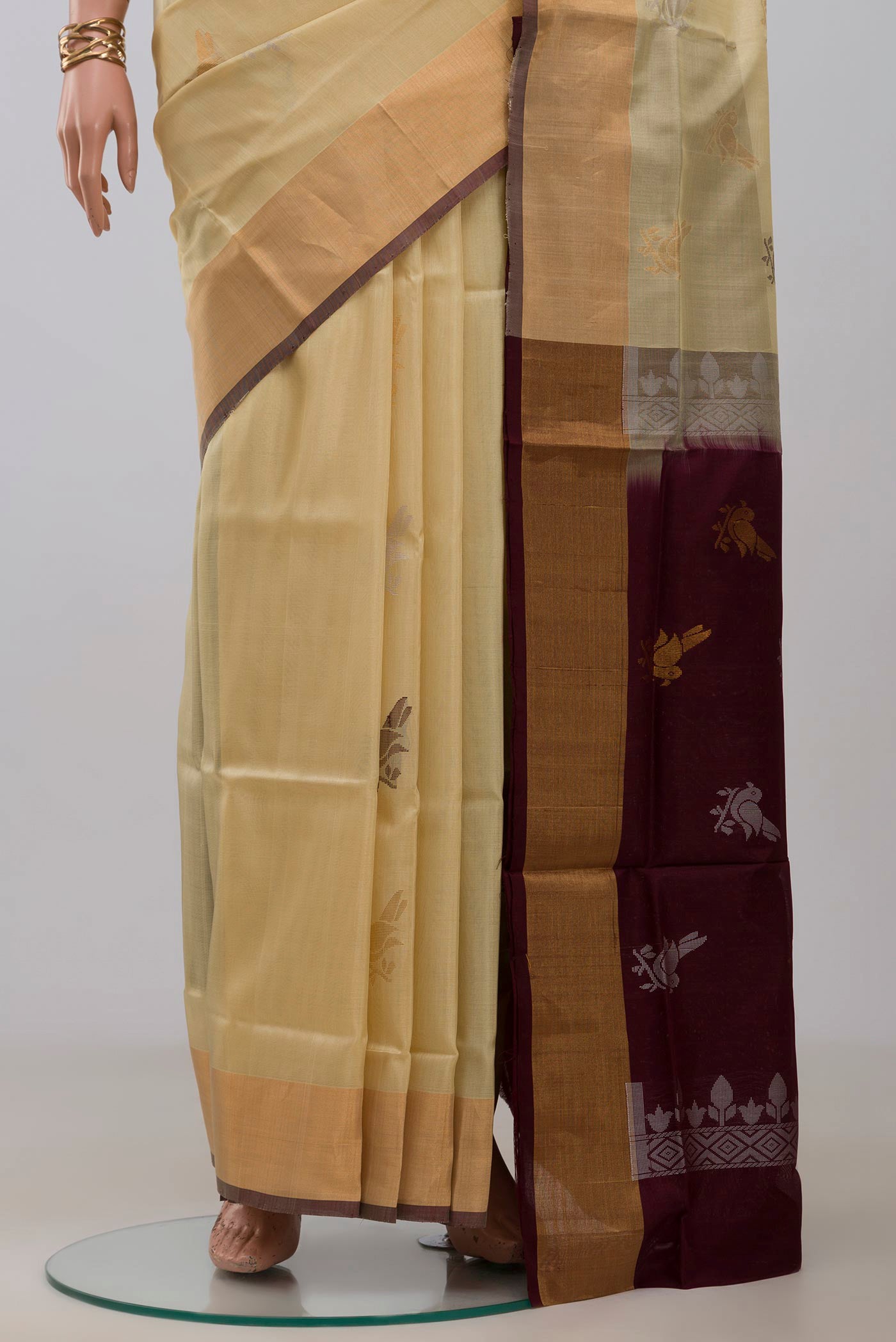 Pleats and pallu of Cream Uppada Silk Saree with Zari And Thread Butta on the body and Zari Border. 